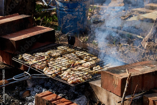 Obraz Ruddy chicken kebab is roasted on the grill