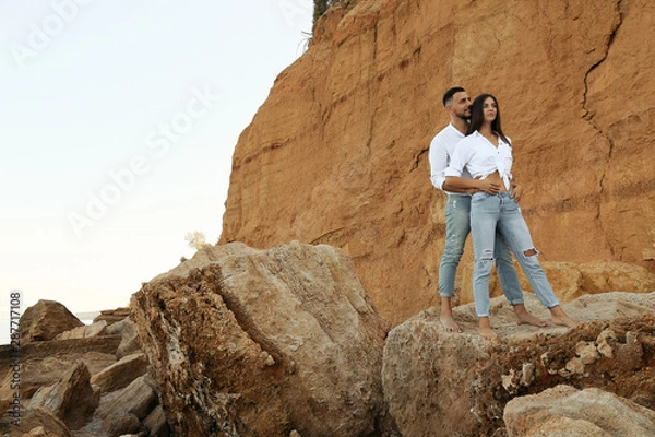 Obraz beautiful lovely couple wearing jeans,posing at summer beach