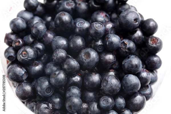 Fototapeta Blueberries in a glass on a white background