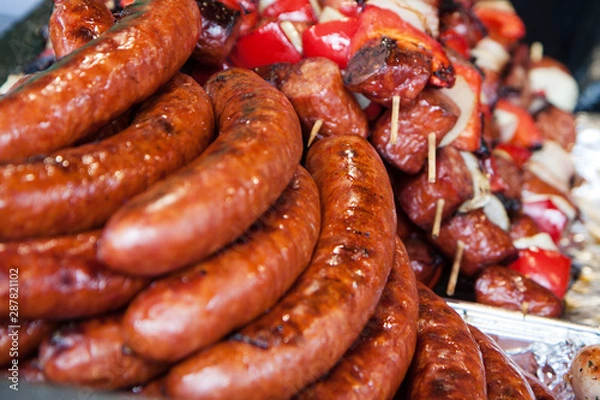Fototapeta Sausages and kebabs on a window display at a street fair