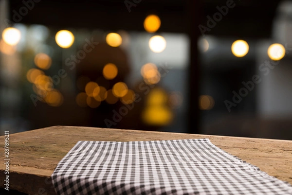 Obraz Empty wood table top on blur light gold bokeh of cafe restaurant in dark background