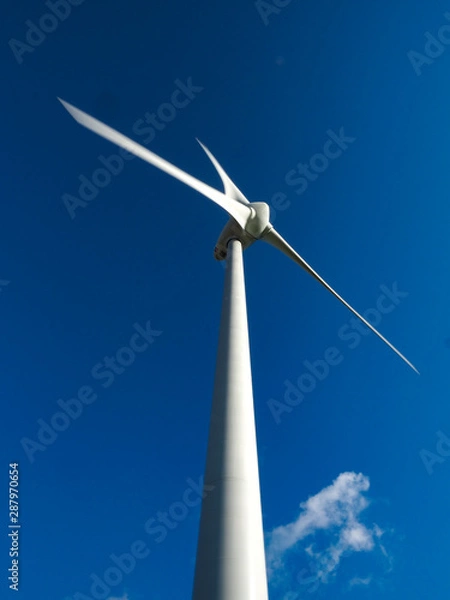 Obraz White wind turbine against a blue sky