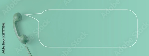 Obraz A green vintage dial telephone handset with green background.