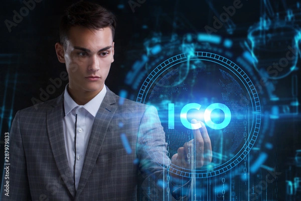 Fototapeta The concept of business, technology, the Internet and the network. A young entrepreneur working on a virtual screen of the future and sees the inscription: ICO