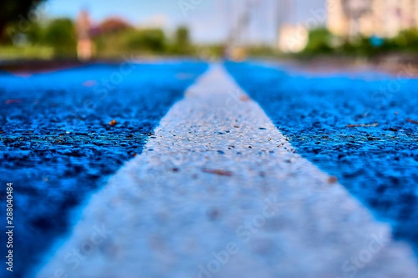 Obraz White dividing strip on a treadmill