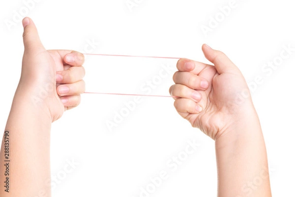 Fototapeta Child hand playing with elastic rubber band isolated on white