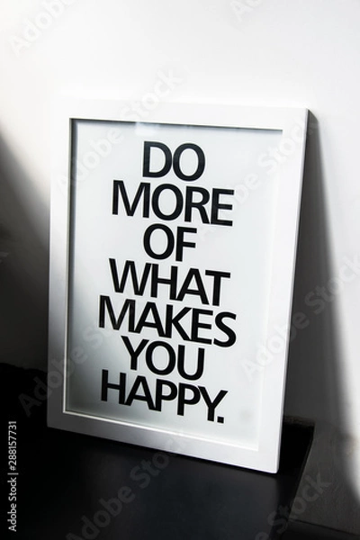 Fototapeta The motivational words Do more of what makes you happy on photo frame near the white wall