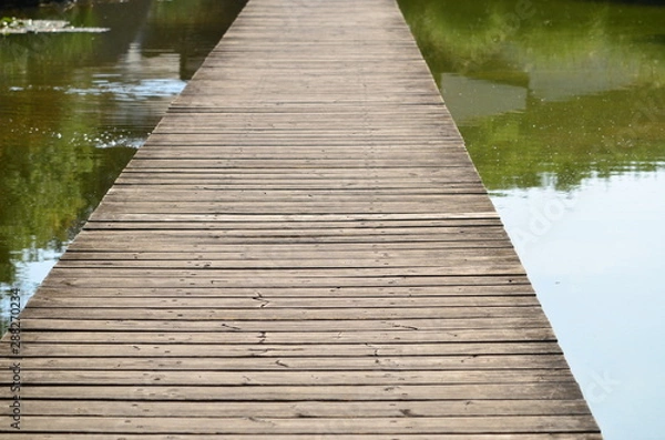 Fototapeta wooden bridge on a lake