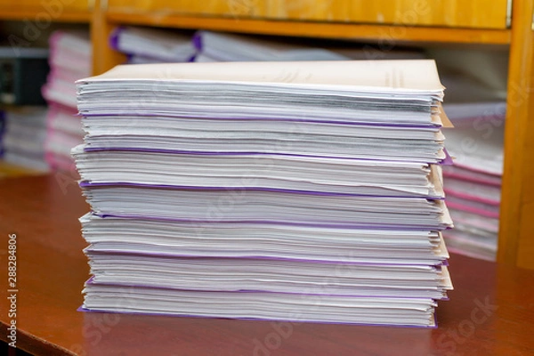 Fototapeta pile of documents on a wooden table. paperwork. data archive. office work