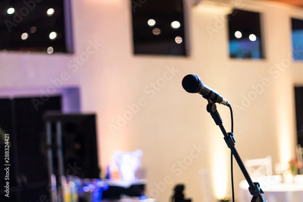 Fototapeta Microphone stand on the stage with blurry background