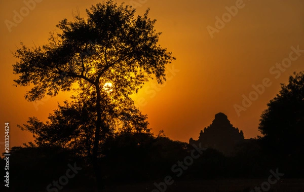 Fototapeta Outlines of an ancient buddhist temple in Bagan, Myanmar at sunset