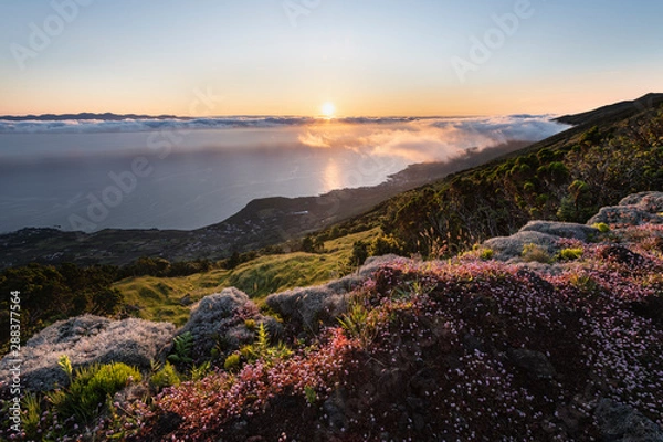 Fototapeta Sunrise landscape at the northeast coast of Pico Island, Ilha do Pico, with Sao Jorge Island in the background and the coastline with Prainha do Baixo,  Canto da Areia, Santo Amaro, and Terra alta.