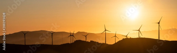 Fototapeta A windfarm with wind turbines at Planalto dos Graminhais in a poetic sunset setting, serving as a perfect image for green sustainable renewable engery.