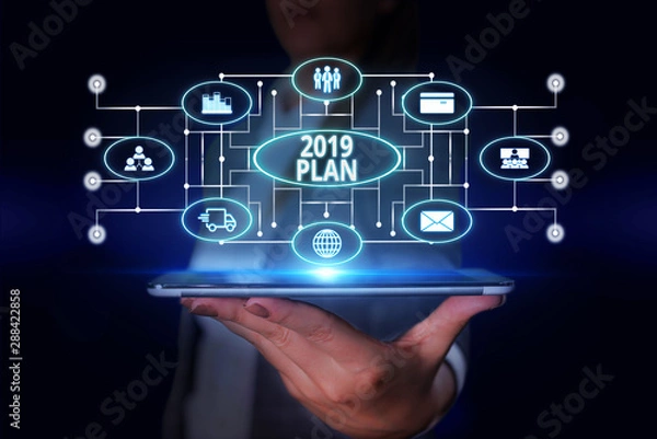 Fototapeta Word writing text 2019 Plan. Business photo showcasing setting up your goals and plans for the current year or in 2019 Woman wear formal work suit presenting presentation using smart device