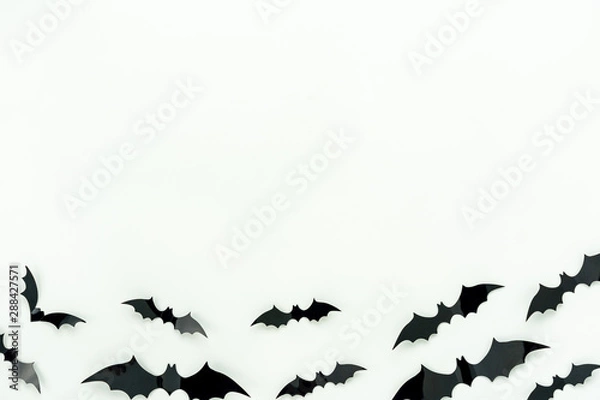 Fototapeta Table top view aerial image of decoration Happy Halloween day background concept.Flat lay accessories essential object to party the bat fly on white wooden wallpaper.Copy space for creative design.