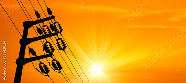 Obraz close up electricity power line tower over orange color sunset sky with shining sun