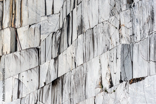 Fototapeta Marble quarry in Carrara, Italy, where Michelangelo got the material for his sculptures. This is the stone wall from which large marble slabs are cut