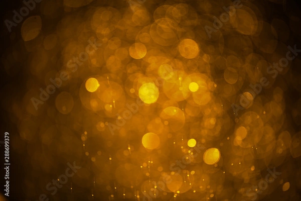 Fototapeta Abstract blurred background of golden water droplets bokeh with light effect