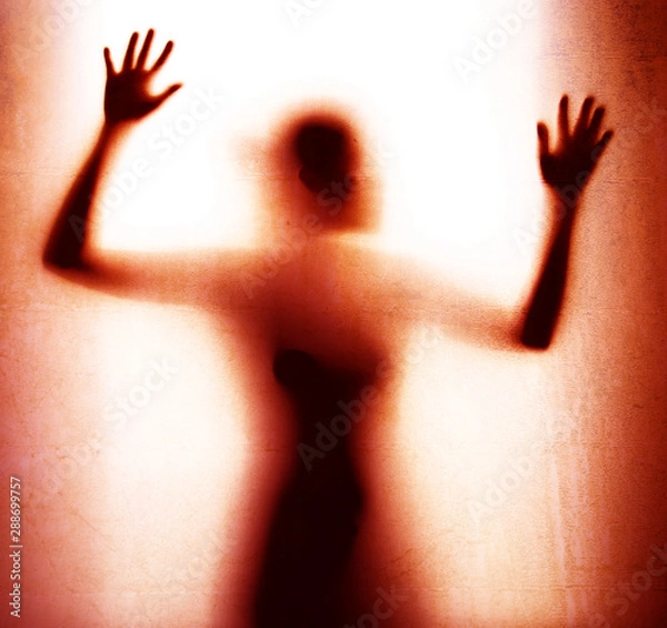 Fototapeta Abstract  shadow of woman body behind red color glass  , concept of attacking fear