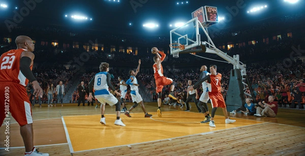 Obraz Basketball players on big professional arena during the game. Tense moment of the game. Celebration