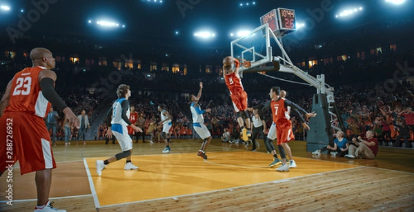 Obraz Basketball players on big professional arena during the game. Tense moment of the game. Celebration