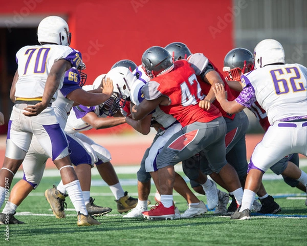 Fototapeta Great action photos of high school football players making amazing plays during a football game