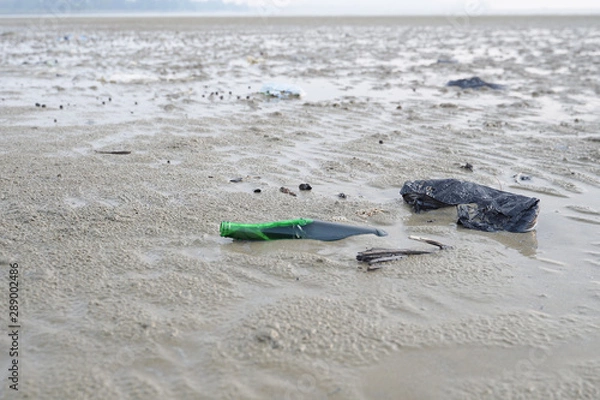 Fototapeta Lok Kawi, Kota Kinabalu, Sabah, Malaysia - September 08, 2019: There is a lot of rubbish left in Lok Kawi Beach. This rubbish are dumped into the sea and washed away to this beach.