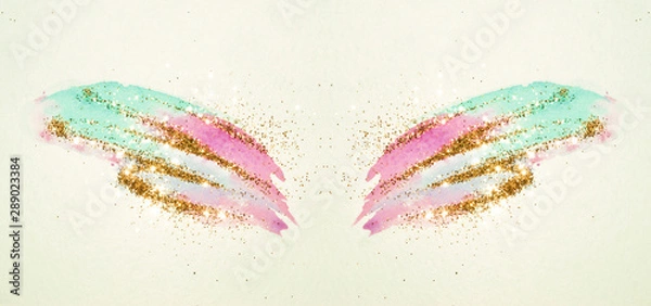 Fototapeta Golden glitter on abstract pink and blue watercolor wings in vintage nostalgic colors.