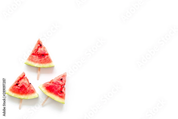 Fototapeta Fresh watermelon on stick for fruit ice cream on white background top view copyspace