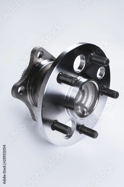 Obraz New Wheel hub assembly with bearing. This is part of the car suspension on a gray background with a gradient. The concept of new car parts