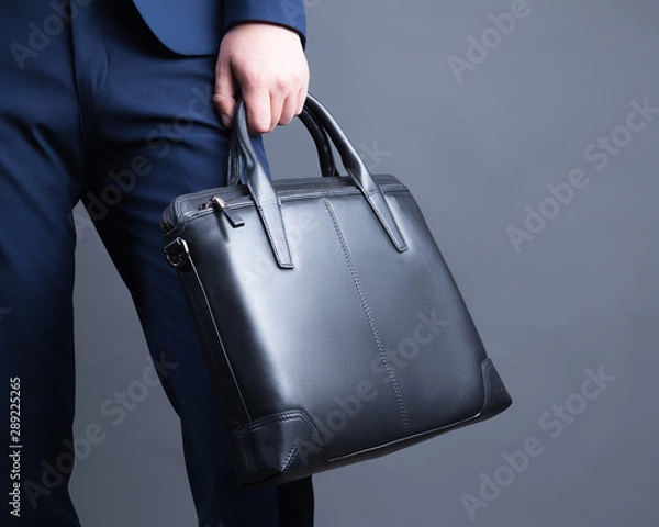 Fototapeta Businessman with briefcase in hand.