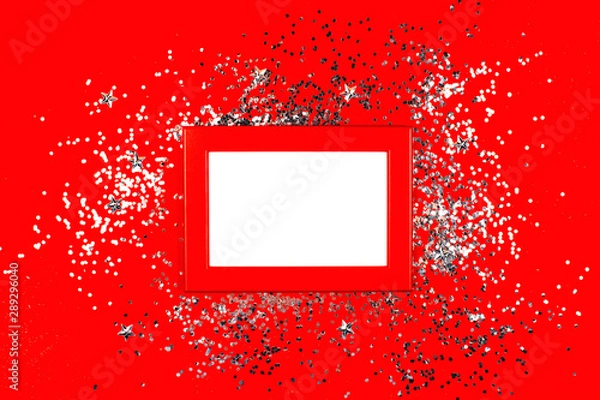 Fototapeta Frame on red background with silver sparkles. Flat lay style. Trendy color.