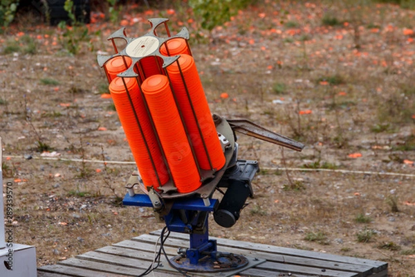 Fototapeta Automatic machine for throwing plates for shooting. Throwing machine for bench shooting. catapult for shooting Skeet