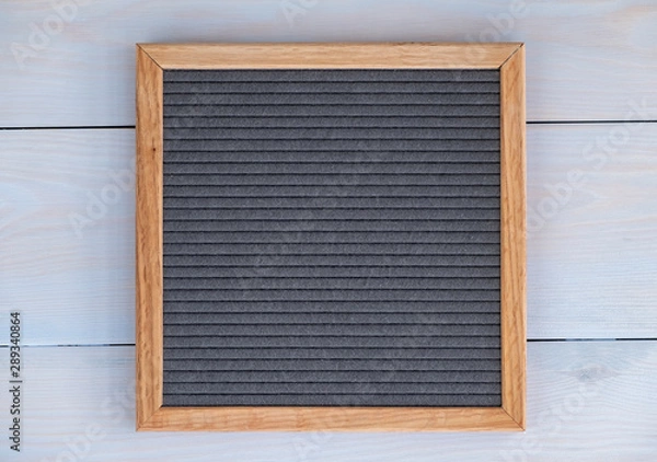 Fototapeta empty grey felt letterboard on natural wood background. procurement for design