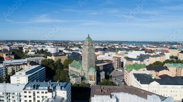 Fototapeta Part of Helsinki city , Kallio church tower in middle. Beautiful summer day, blue sky and clouds