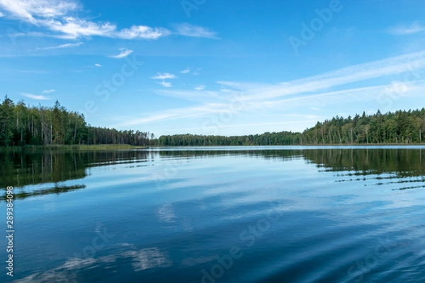 Fototapeta beautiful lake view, beautiful sky, Calm lake reflection against the blue sky with white clouds, Valdis lake, Turna, Latvia