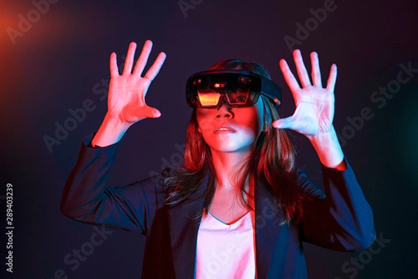 Fototapeta Business woman try vr glasses hololens in the lab room. Mixed reality future technology concept