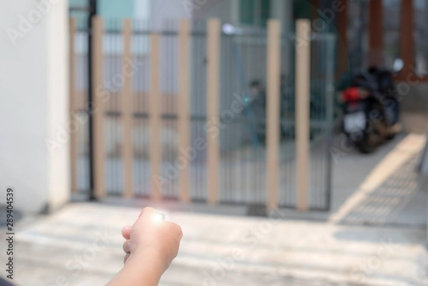 Obraz People are using a remote to open the automatic gate