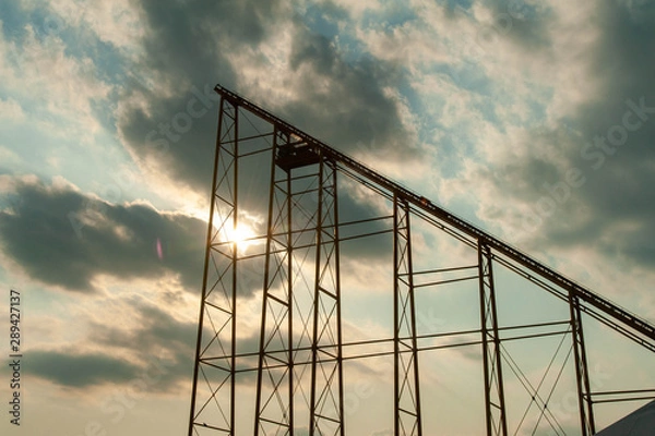 Fototapeta 夕日の空とジェットコースターの土台
