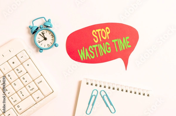 Fototapeta Word writing text Stop Wasting Time. Business photo showcasing advising demonstrating or group start planning and use it wisely Blank paper with copy space on the table with clock and pc keyboard