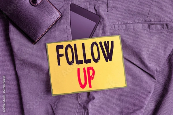 Fototapeta Conceptual hand writing showing Follow Up. Concept meaning a continuation of something that has already been started Smartphone device inside trousers front pocket with wallet