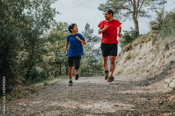 Obraz father and son running in the mountain