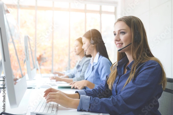 Fototapeta Call Center Service. Photo of customer support or sales agent.  Help line answering and telemarketing. Female caller or receptionist phone operator.Copy space for some text, advertising or slogan.