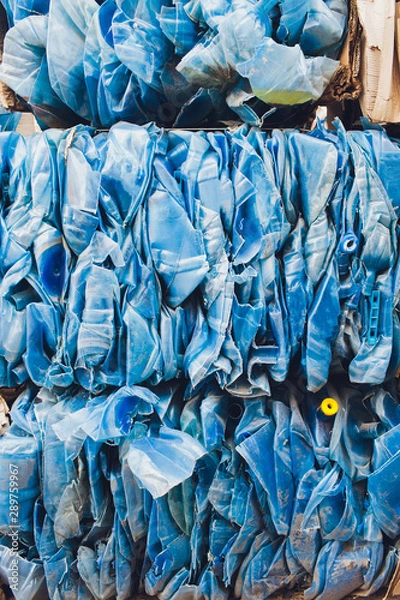 Fototapeta Plastic pressed bales at the modern waste hazardous processing plant. Separate garbage collection. Recycling and storage of waste for further disposal. Business for sorting and processing of waste.