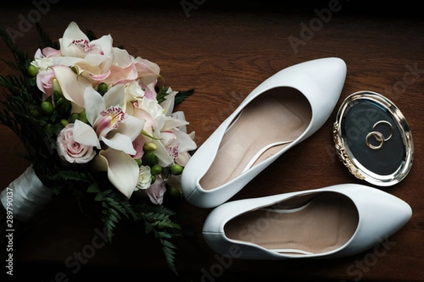 Fototapeta Wedding still life of flowers rings and shoes bride.