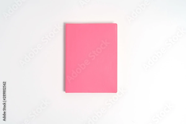Obraz Pink notebook on white desk. Business minimal concept for women. Flat lay, top view, copy space