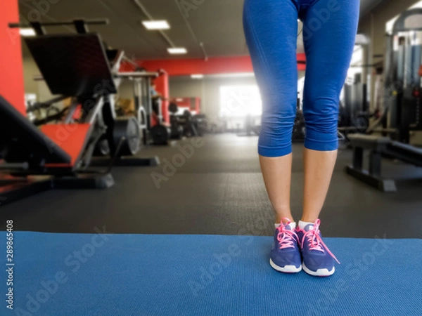 Fototapeta girl performs exercises in the gym
