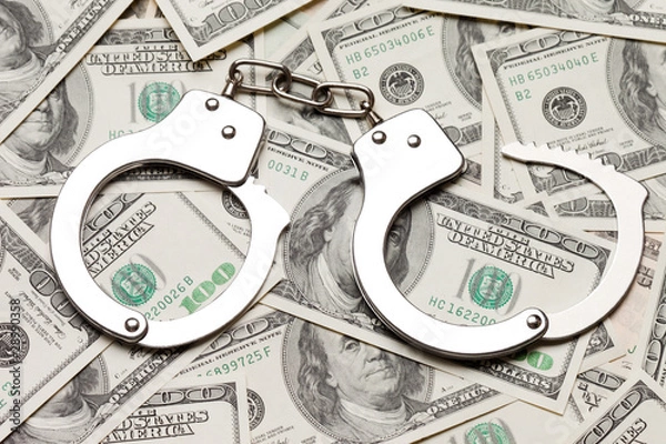 Obraz Handcuffs on dollar currency