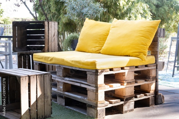 Obraz Upcycled outdoor seat made from pallets with wood crate as table