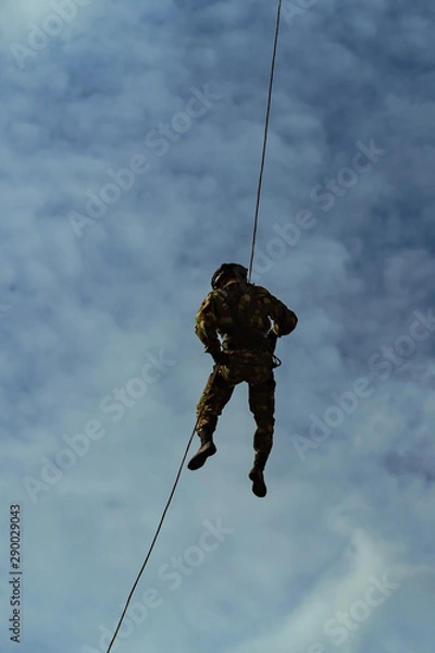 Fototapeta Special Forces descends the rope at a military airfield
